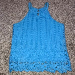 A baby blue top that is a women’s size 00.